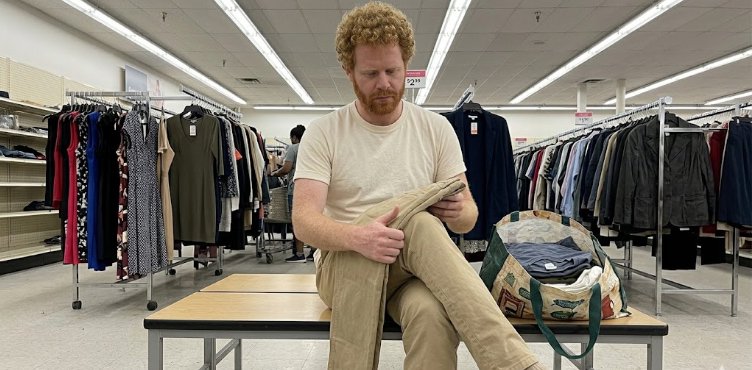Man checking straight chino side seam in discount store