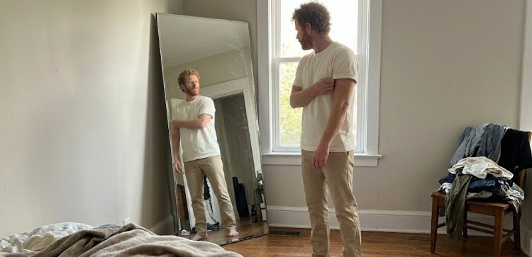 Man with balanced outfit proportions tee hits mid-fly chinos single break